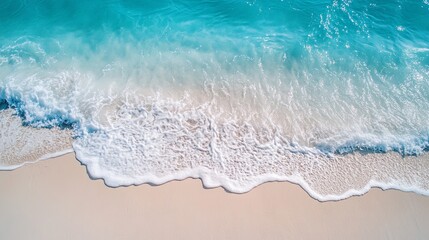 Soft waves forming patterns on white beach sand .