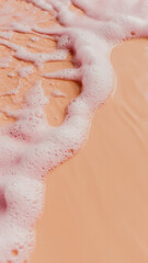 Fototapeta premium Macro photograph of pink foamy liquid with ripples and bubbles against a peach-colored background