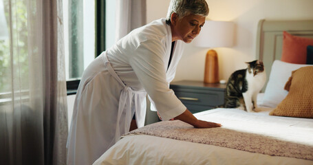 Woman, sheets and tidy bed in home for cleaning, morning habit and resting place for cat. Mature pet owner, blankets and straighten in bedroom for animal care, daily routine and linen maintenance