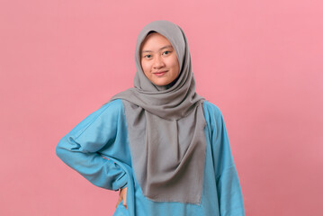 Confident Indonesian Muslim Girl in Casual Outfit with Hand on Hip, Studio Portrait