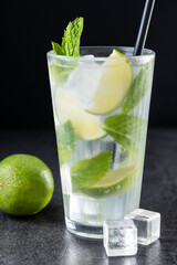 Classic Mojito Cocktail with Lime and Mint on black background