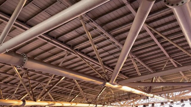 Engineering view of a stadium roof structure featuring I-beams, diagonal bracing, welded joints, and lighting support nodes. 