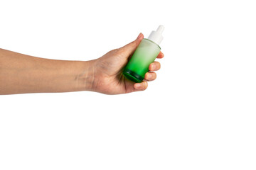 Green glass cosmetic bottle, Skin care or sunscreen cosmetic with hand on transparent background.