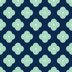 Vector pattern with green four-petal decorative flowers on a blue background