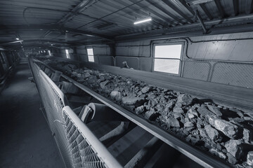 Belt conveyor in underground tunnel of concentrating plant. Transportation of ore to surface factory