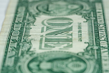 Vertical macro of big letters ONE on one dollar US America currency bill in god we trust
