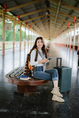 A young woman is waiting at a train station.