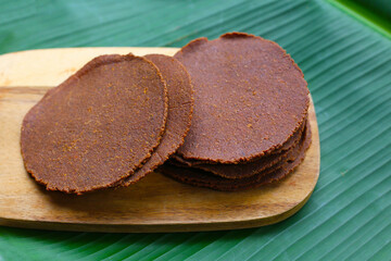 Fermented soybean discs, known as “Thua Nao,” a traditional Thai seasoning used to enhance flavor in Northern cuisine.