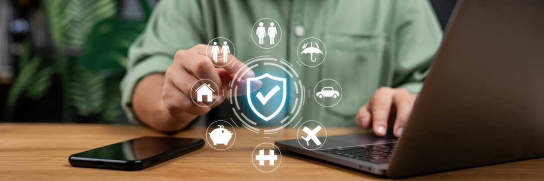 Person interacting with a holographic display of various insurance icons. - Powered by Adobe