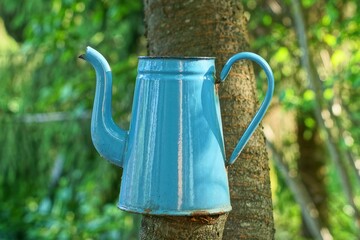 one enameled  kitchen original blue shiny rusty with handle industrial old empty teapot stands on...