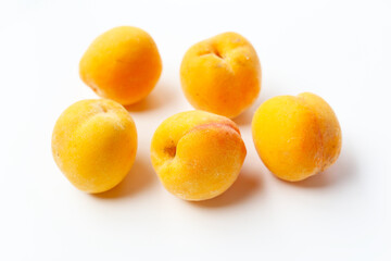 Fresh ripe apricots on a white background.