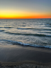 Golden sunset over calm sea. Image for travel topics.
