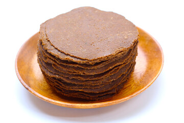 Fermented soybean discs, known as “Thua Nao,” a traditional Thai seasoning used to enhance...