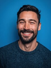 Fototapeta premium Smiling male portrait studio setting close-up photography bright blue background vibrant mood personal branding concept