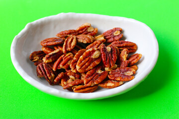 Delicious salted pecan nuts scattered.