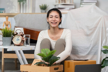 Moving joy. Happy woman unboxing new items in her living space.