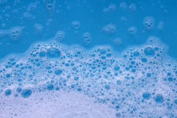 Blue water with white foam bubbles