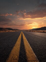 Fototapeta premium A long road leading into the distance with yellow lines on it, a sunset in the background