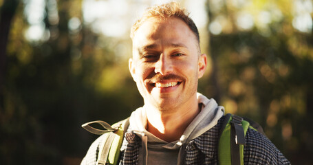 Travel, hiking and portrait of man in nature for trekking, adventure and wilderness explore. Eco tourism, backpacking and journey with male person in forest for vacation, peace and wellness trip