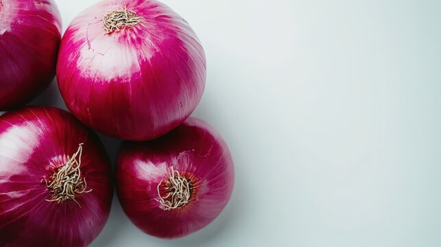 This image showcases a grouping of fresh red onions against a clean white backdrop, emphasizing their vibrant color and appealing texture for culinary imagery. - Powered by Adobe