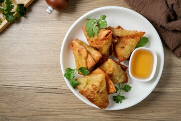 Samosas in a white plate on wooden background ,indian fried samosa, indian snack