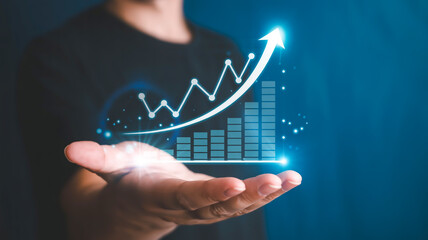 A digital marketing and business growth concept image with a glowing holographic financial chart floating above an open human hand against a deep blue background.