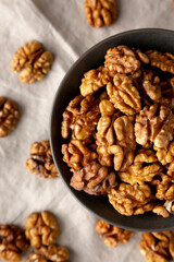 Raw Walnut Halfs in a Bowl, top view. Flat lay, overhead. Close-up.
