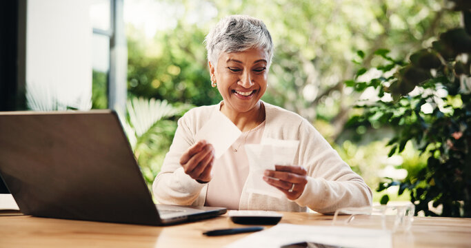 Senior, happy woman or laptop with receipts for tax return, deduction or finance at home. Mature, female person and smile with payslips or invoices for financial profit, banking or salary at house