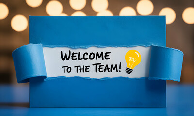 Blue envelope with torn paper revealing "Welcome to the Team!" message and lightbulb graphic