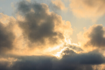 beautiful dramatic sunset sky with clouds and sun behind clouds
