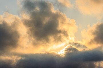 beautiful dramatic sunset sky with clouds and sun behind clouds