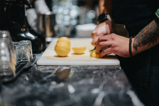 A bartender skillfully slicing lemons for drinks, showcasing expert craftsmanship at a modern bar.