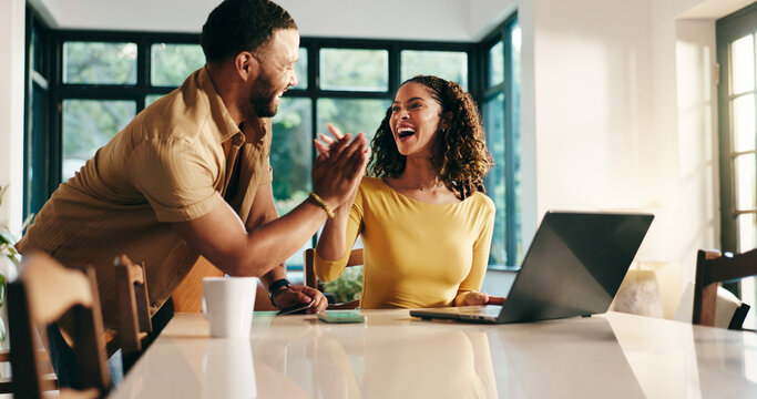 Planning, laptop and high five with couple in kitchen for travel itinerary, flight booking and vacation package. Man, woman and excited with passport application, airline review and happy in home