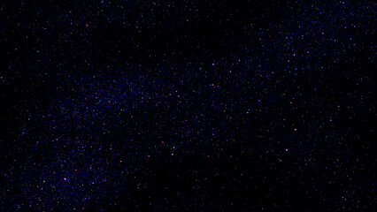 Starry night sky colourful glitter light sparkle background. Dark blue night galaxy space. Glowing stars. New Year, Christmas and Celebration background concept.