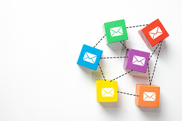Colorful wooden block with email envelope icon connected in a network.Concept for email...