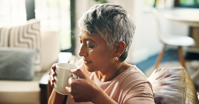 Coffee, relax and senior woman on sofa in home with calm and peace in living room in morning. Happy, memory and elderly female person in retirement drinking cappuccino on couch in house on break. - Powered by Adobe