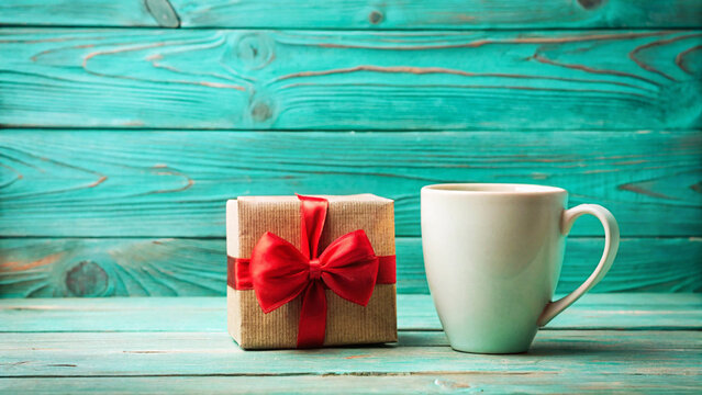 Gift and Coffee A Cozy Morning Surprise on Teal Wooden Background