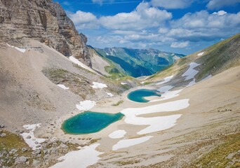 Monte Vettore and Pilato lake (Italy) - The landscape summit of Mount Redentore with Lago di Pilato lake, between the regions Umbria and Marche, touristic landmark in the Monti Sibillini mountain natu