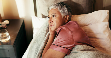 Thinking, tired and worry with old woman in bed for insomnia, reflection and retirement. Fatigue,...