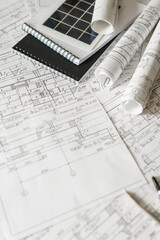 sustainable architecture tools and materials: blueprints, solar panel, wood textures, fabric swatches, and stones. Eco-friendly design, conscious construction and green innovation.	