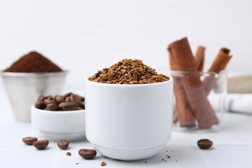 Granulated instant coffee and beans on light table, closeup