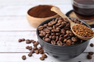 Roasted beans and granulated instant coffee on white wooden table, closeup