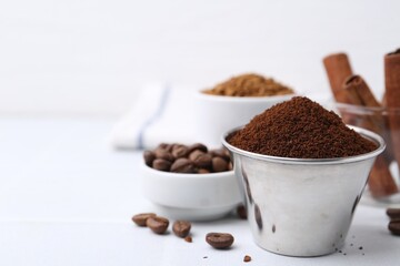 Instant coffee powder and beans on light table, selective focus. Space for text