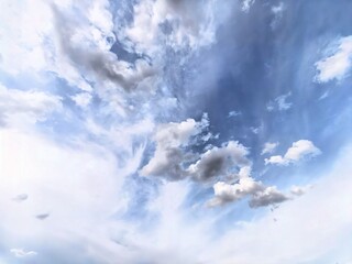 Expansive blue sky with scattered white and grey clouds