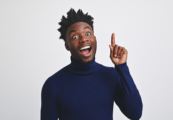 Excited Man in Blue Turtleneck Pointing Up – Portrait with Happy Expression, White Background, Ample Space for Text, High-Resolution Studio Photography for Advertising & Social Media Concepts