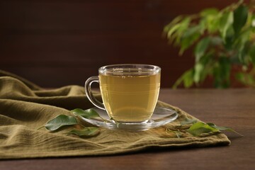 Cup of tasty green tea on wooden table