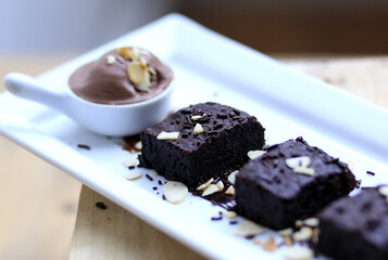 Indulge in a decadent brownie lava cake, rich and warm, perfectly paired with a scoop of creamy chocolate ice cream. A delightful dessert experience