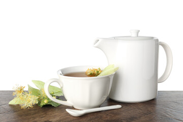 Tasty linden tea in cup, teapot, leaves and flowers on wooden table against white background