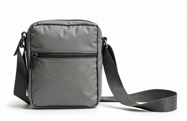 Naklejka premium Compact crossbody bag isolated on white. Practical everyday carry with muted gray soft fabric texture. Fashionable urban accessory for women. Modern bag design with adjustable strap.