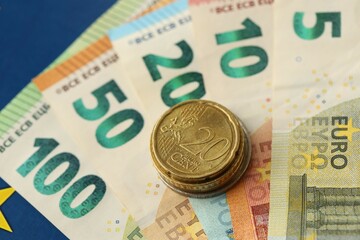 European union money currency Euro different paper notes and coins on flag
